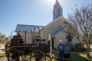 Chuck wagon in front of chapel.
