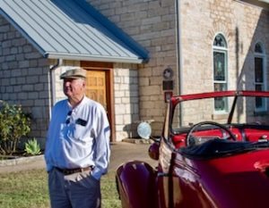 Photo of classic car in front of chapel