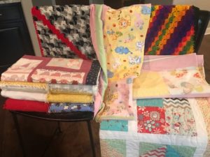 Display of folded quilts.