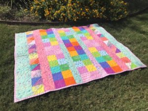Large quilt on grass in front of chapel