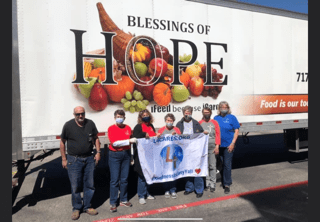 Volunteers in front of community food drive truck